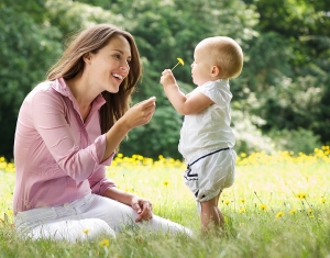 Mother Giving Child Flower In The Park about nannypay