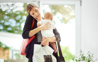 busy working mother with her baby in hand
