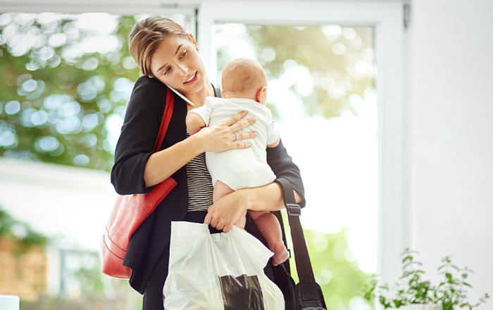 busy working mother with her baby in hand